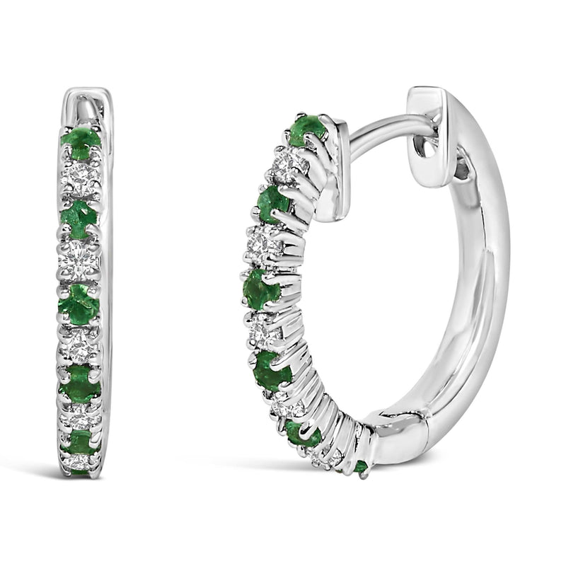 10K White Gold Alternating Emerald 1/10 Cttw Diamond Huggy Hoop Earrings (I-J Color, I1-I2 Clarity) 10K white gold hoop earrings with round diamond and green emerald stones