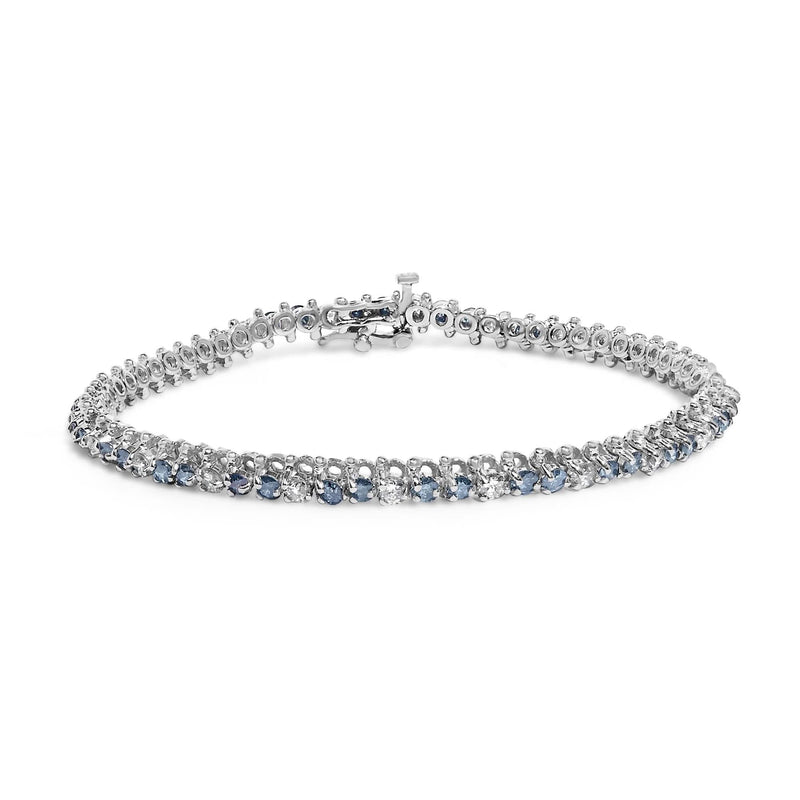 14K White Gold White And Treated Blue Diamond Bracelet (4 5/8 cttw, H-I Color, I1-I2 Clarity) 14K white gold bracelet with white and treated blue diamond stones