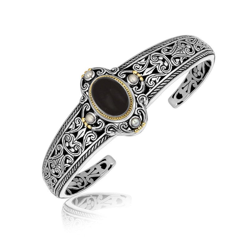 18K Yellow Gold and Sterling Silver Bangle with an Oval Black Onyx and Pearls 18K yellow gold and silver bangle with oval black onyx and round pearls