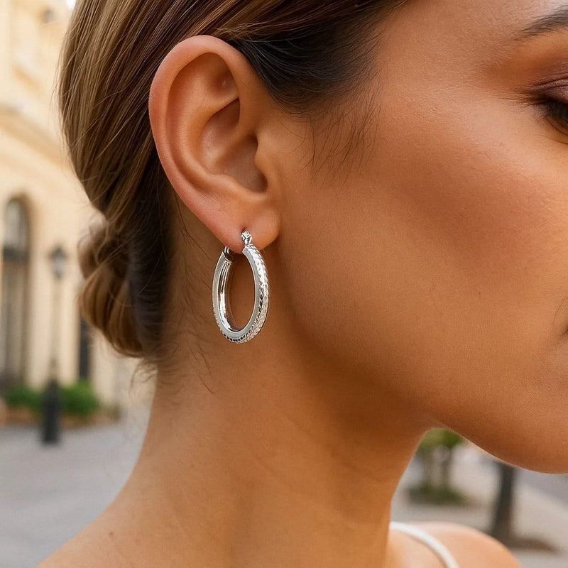 14k White Gold Diamond Cut Textured Oval Hoop Earrings. Product Image