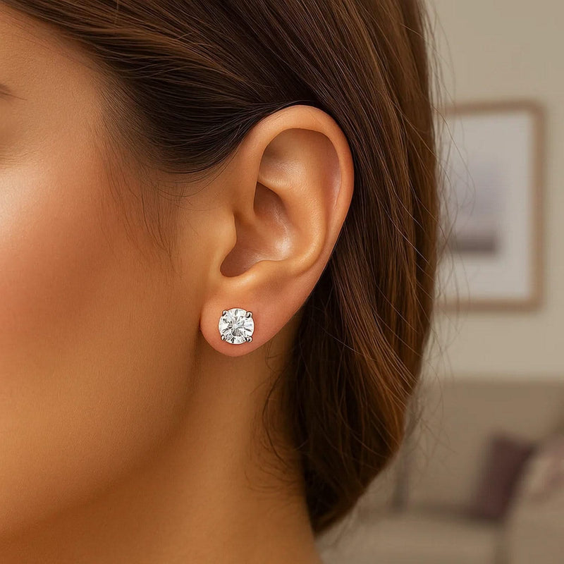 14k White Gold Stud Earrings with White Hue Faceted Cubic Zirconia(6mm) 14K white gold stud earrings with 1 round faceted cubic zirconia stone