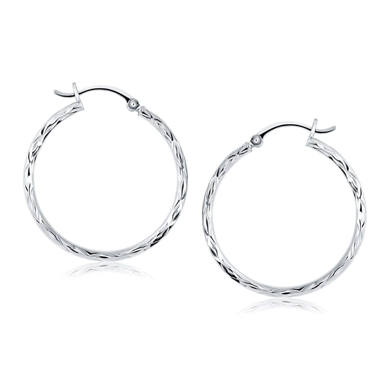 14k White Gold Diamond Cut Hoop Earrings 14K white gold hoop earrings with diamond-cut faceted surface