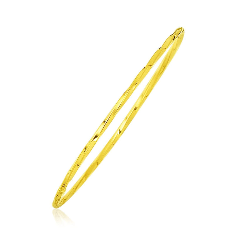 14K yellow gold thin twisted slip-on bangle with shiny finish