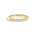 14K gold ring with 7 round diamond stones in a row across the band