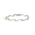 10K two-tone gold bracelet with X and wave links set with diamond stones