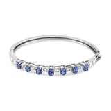 14K white gold bangle with oval blue tanzanite and diamond accent stones thumbnail 1