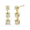 14K gold ring with 3 round diamond stones in a graduated line