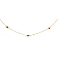 14K yellow gold station necklace with oval ruby bezel-set stones