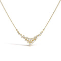 14K yellow gold necklace with scattered round diamond stones in a V