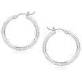 14K white gold diamond-cut hoop earrings with faceted reflective surface