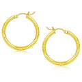 14K yellow gold diamond-cut hoop earrings with faceted 25mm profile