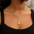 14K yellow gold teardrop shape long pendant with polished curved surface