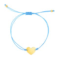 14K yellow gold bracelet on blue cord with heart-shaped gold accent