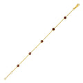 14K yellow gold station bracelet with round garnet stones