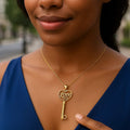 14K yellow gold skeleton key pendant spelling LOVE in openwork letters