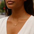 14K yellow gold cross pendant necklace with a polished finish