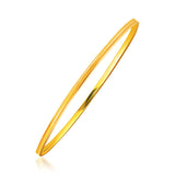 14K yellow gold thin stackable bangle with concave motif center channel thumbnail 1