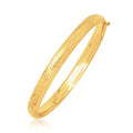 14K yellow gold children's dome bangle with diamond-cut facets