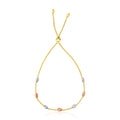 14K tri-color gold lariat bracelet with textured oval gold stations