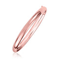 14K rose gold fancy shiny dome bangle with smooth polished surface