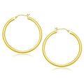 10K yellow gold polished hoop earrings in a 40 mm rounded tube profile