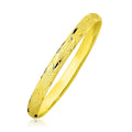 10K yellow gold bangle with slender diamond-pattern textured surface